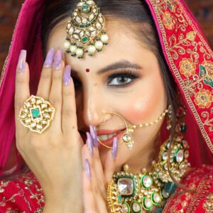 Professional makeup artist applying flawless bridal makeup using premium products, highlighting the importance of hiring a professional makeup expert for a perfect look.| NS MAKEUP STUDIO